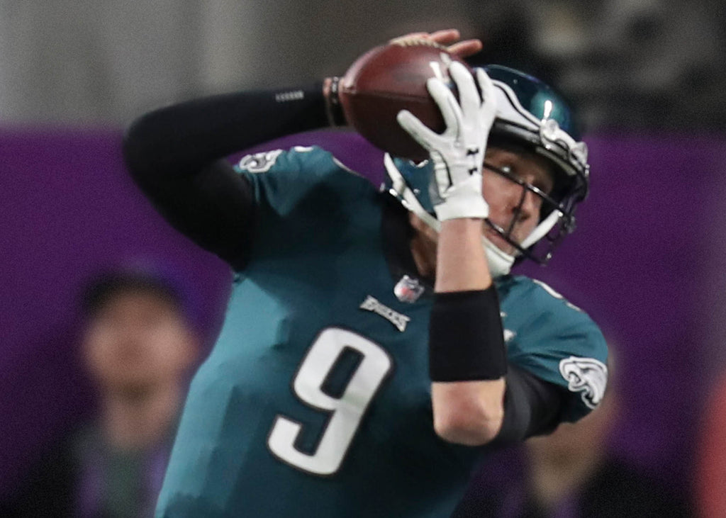 Philadelphia Eagles quarterback Nick Foles (9) catches a touchdown pass during the first half of the NFL Super Bowl LII football game against the New England Patriots on Sunday, Feb. 4, 2018, in Minneapolis. The Eagles won 41-33. (Perry Knotts via AP)
