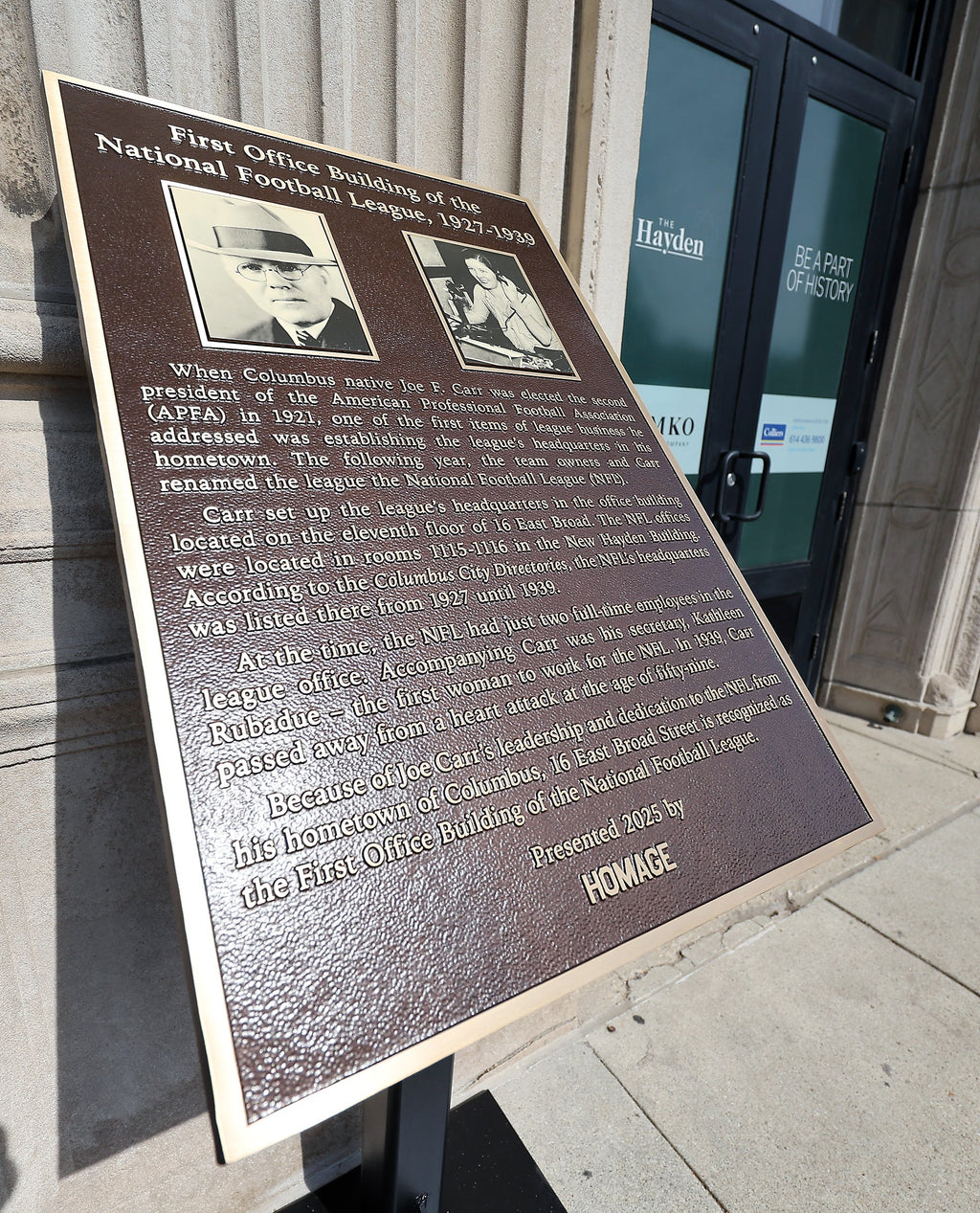 The historical plaque for the first NFL office building is unveiled at 16 East Broad Street in Columbus, Ohio.