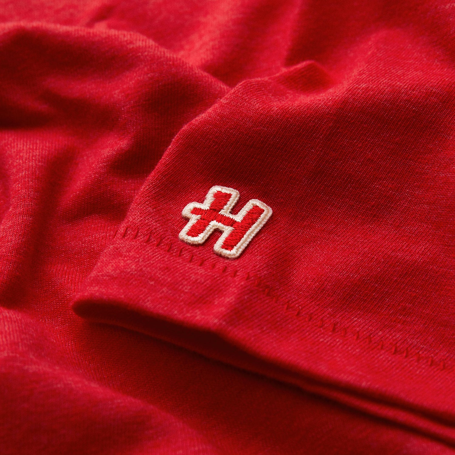 Zoomed in Homage logo on t-shirt sleeve